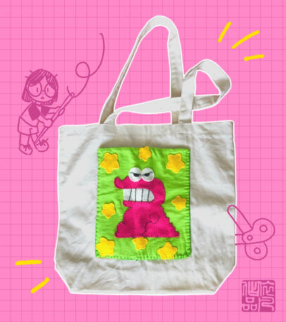 image of a white tote with a felted pocket inspired by the chocobi snack from Crayon Shin Chan. the pocket is designed using scrap fabrics so there are various textures between the magenta dinosaur, the yellow stars, and green background.