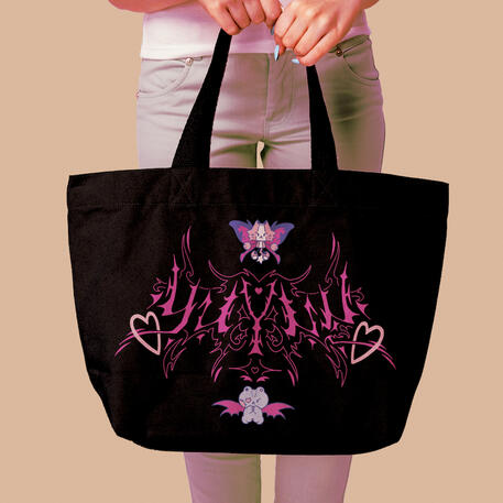 image of a black tote being held. the design on the bag is of the word 'yuyuu' in a pink, spiky, cybersigilism style. the two yuyuu mascots, the robot tiger and the stitched teddy bear, adorn the top and bottom of the logo.